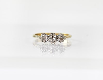 Lot 905 - An 18ct gold ring set with three diamonds,...