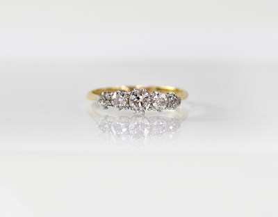 Lot 908 - An 18ct gold ring set with five diamonds, size...