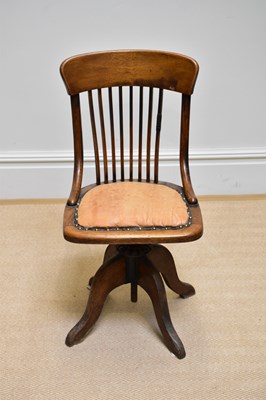 Lot 1140 - A 1920s oak office chair with leather seat.