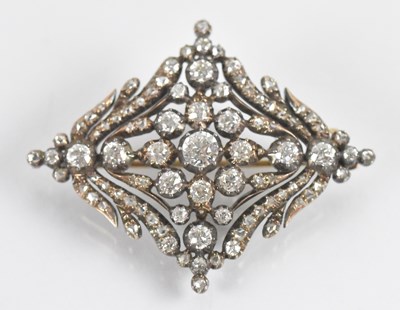 Lot 713 - A yellow metal diamond set brooch, the central...