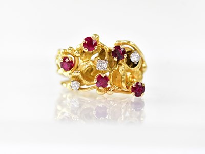 Lot 911 - An 18ct gold ring in the form of intertwined...