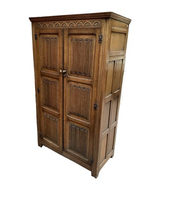 Lot 1105 - A reproduction oak twin door wardrobe with...