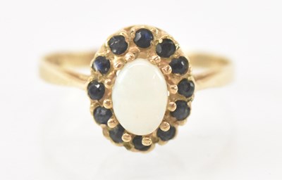 Lot 849 - A 9ct yellow gold opal and garnet set ring,...