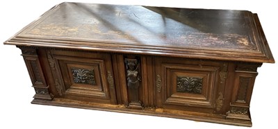 Lot 24 - A large Continental carved walnut two door...