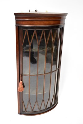 Lot 56 - An Edwardian mahogany bowed and glazed corner...