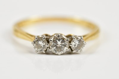 Lot 56 - An 18ct yellow gold and platinum diamond three...