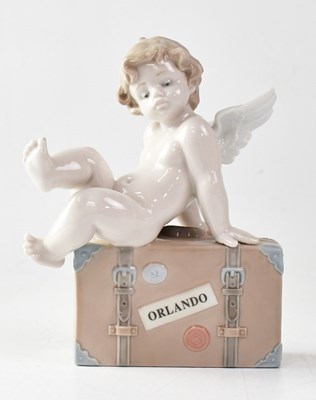 Lot 264 - LLADRÓ; a figure of a cherub on a suitcase,...