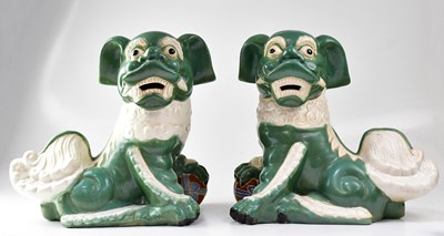 Lot 139 - A pair of green and white ceramic dogs of Fo,...