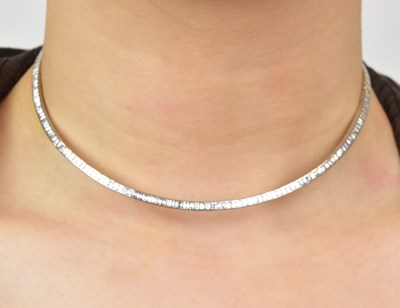 Lot 1085 - An 18ct white gold diamond set choker, the...