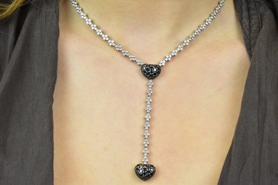 Lot 1086 - An 18ct white gold diamond and black diamond...