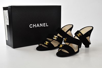 Lot 929 - CHANEL; a pair of unused black suede crossover...