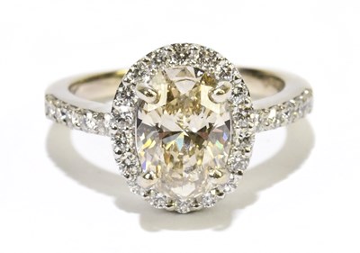 Lot 1007 - An 18ct white gold diamond cluster ring, the...