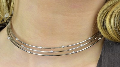 Lot 1095 - An 18ct white gold diamond set collar formed...