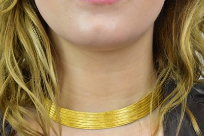 Lot 1098 - A Middle Eastern yellow metal flat link choker...