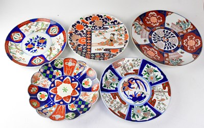 Lot 174 - Five Japanese Imari decorated chargers,...