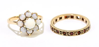 Lot 1189 - A 9ct yellow gold and opal flower head ring,...