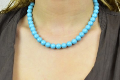 Lot 1124 - A turquoise bead necklace with diamond set...