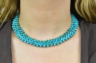 Lot 1126 - A turquoise and white metal bead necklace with...