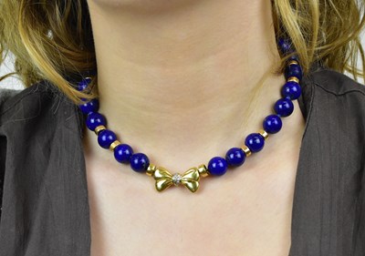 Lot 1138 - An 18ct yellow gold and lapis lazuli bead...