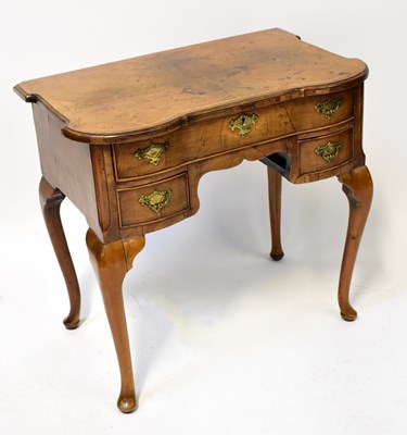 Lot 81 - An 18th century walnut lowboy with shaped top...