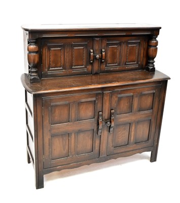 Lot 51 - ERCOL; a dark stained elm court cupboard,...