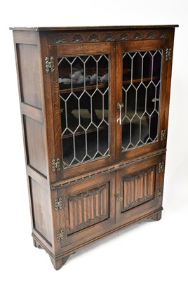 Lot 64 - A mid-20th century oak leaded glazed bookcase...