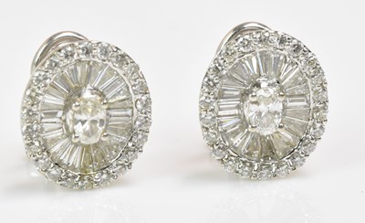 Lot 1153 - A pair of 18ct white gold and diamond earrings,...