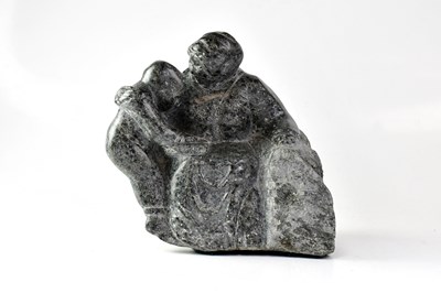 Lot 384 - A Canadian Inuit soapstone carving of a mother...