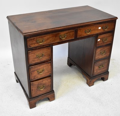 Lot 36 - A 19th century mahogany kneehole desk with two...