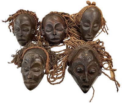 Lot 546 - Four Chokwe masks with carved decoration and...