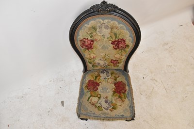 Lot 1568 - A Victorian ebonised nursing chair, the back...