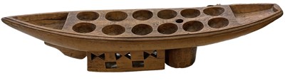 Lot 567 - An African carved Mancala Oware board,...