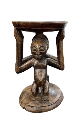 Lot 575 - An African carved wooden Luba or Hemba stool,...