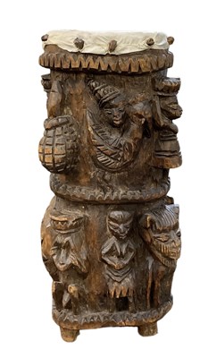 Lot 576 - An African carved wooden drum, with figural...