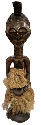 Lot 544 - An African carved hardwood female Songye...