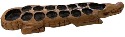 Lot 561 - An African carved wooden Oware Mancala game,...