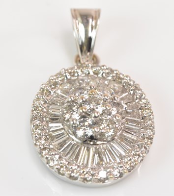 Lot 1154 - An 18ct white gold and diamond pendant of oval...