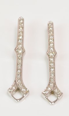 Lot 1155 - A pair of white metal and diamond set drop...