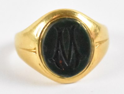 Lot 835 - A yellow metal agate set signet ring, marked...