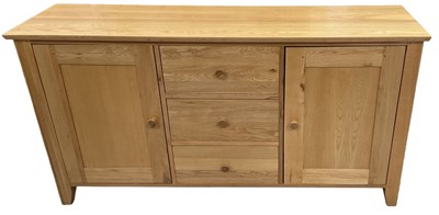 Lot 65 - A modern light oak sideboard, with three...