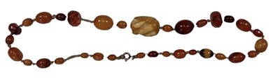 Lot 832 - An antique amber bead necklace set with...