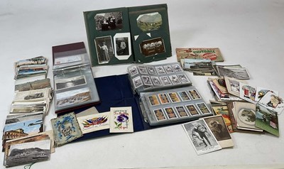 Lot 257 - A collection of postcards and cigarette cards,...