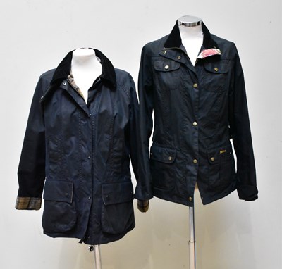 Lot 898 - BARBOUR; two waxed navy blue jackets, one with...