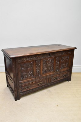 Lot 1031 - An 18th century style carved oak coffer with...