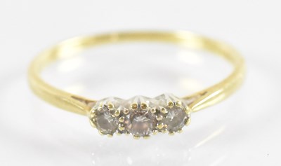 Lot 772 - A 18ct yellow gold three stone diamond ring,...