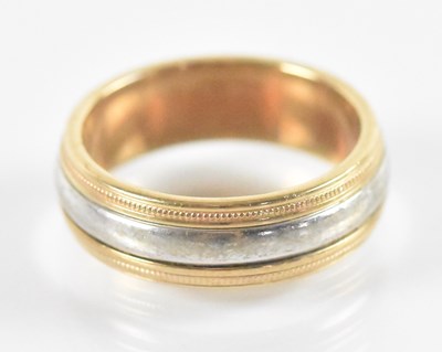 Lot 821 - A 9ct yellow and white gold band, size S,...