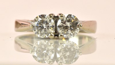 Lot 1268 - A white metal and diamond two stone ring, each...