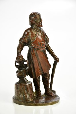 Lot 1596 - A bronze car mascot modelled as blacksmith,...