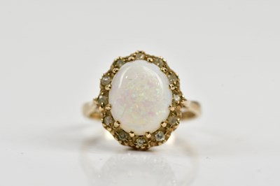 Lot 133 - A 9ct yellow gold opal and diamond oval ring,...