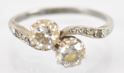 Lot 733 - A platinum diamond crossover ring set with two...